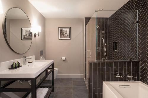 a bathroom with a sink and a shower and a tub at Shelburne Springs Hotel in Shelburne Falls