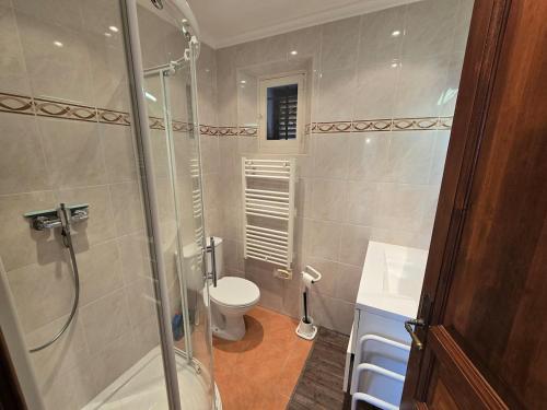 a bathroom with a shower and a toilet at Villa Vue Panoramique sur les îles de Lérins in Saint-Raphaël
