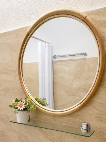 a round mirror on a wall with a window at Pensiune Family & Friends Crit 168 in Criţ