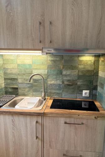 a kitchen with a sink and a counter top at Vasiliki Palli Rooms in Methana