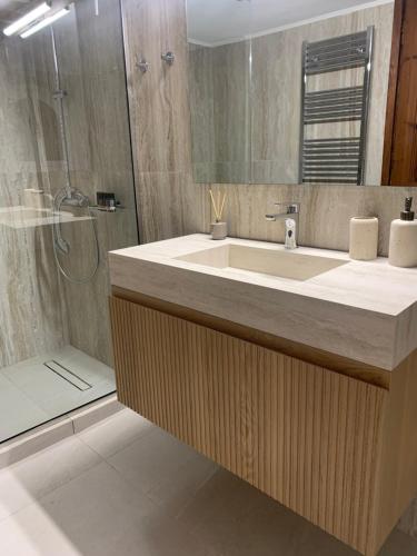 a bathroom with a sink and a shower at Villa Avly in Maleme
