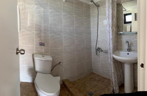 a bathroom with a toilet and a sink at Zourpos Studios in Kalyves