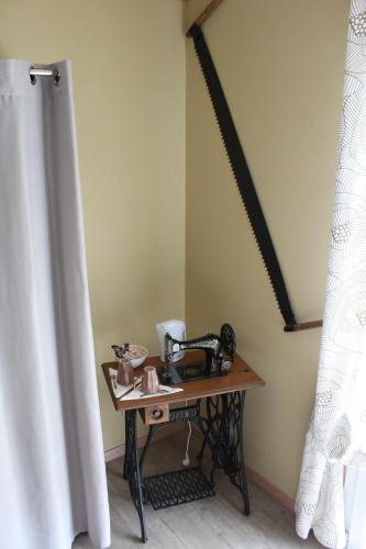 a table with a telephone on it in a room at Du Coté de Lacoume in Anla