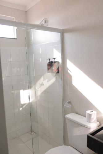 a bathroom with a glass shower and a toilet at Hotel Macapaba in Macapá