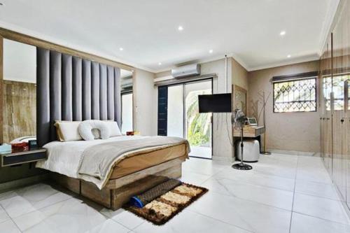 a bedroom with a bed and a television in it at Magic garden in Vereeniging