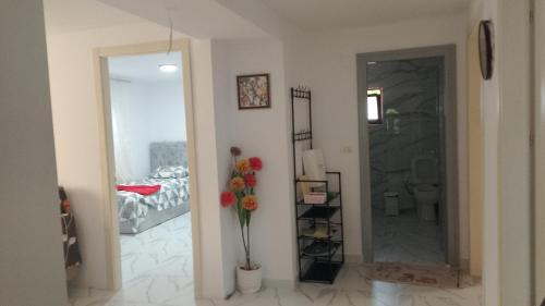 a living room with a mirror and a vase of flowers at ArsonGuest in Berat