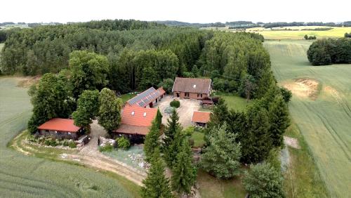 an aerial view of a farm with a train at Siedlisko Żywe Kamienie in Naguszewo