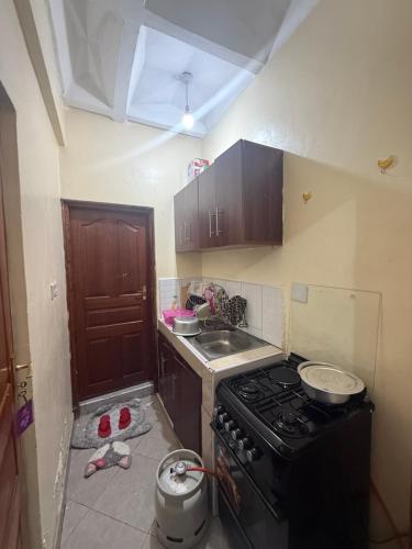 a kitchen with a stove and a sink at Arabella Homes in Maralal