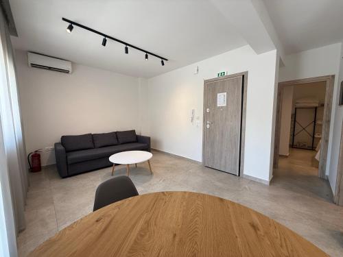 a living room with a couch and a table at K78 Studios B1 in Nea Michaniona