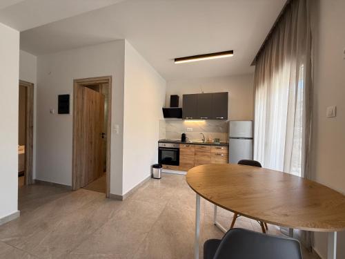 a kitchen with a wooden table in a room at K78 Studios B1 in Nea Michaniona