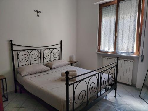 a bedroom with a black bed with two windows at Brilu in Savona