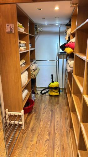 a walk in closet with wooden shelves at Friendly House in Bolesławiec