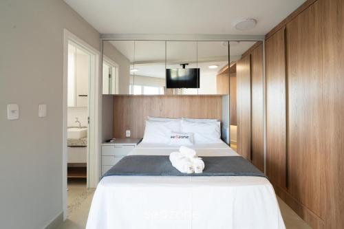 a bedroom with a bed with a white stuffed animal on it at Studio in Condo. w/ Pool in Downtown MSU0406 in Governador Valadares