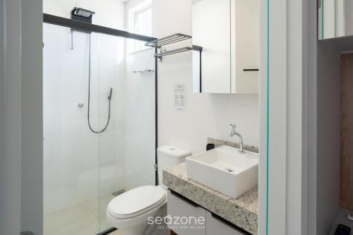 a bathroom with a toilet and a sink at Studio in Condo. w/ Pool in Downtown MSU0406 in Governador Valadares