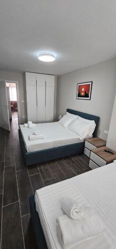 a bedroom with two beds in a room at Sandy Vibes Apartments in Durrës