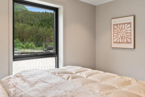 a bedroom with a bed and a large window at Villa in Stryn in Stryn