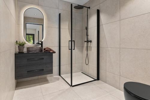 a shower with a glass door in a bathroom at Villa in Stryn in Stryn