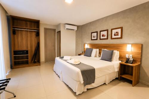 a hotel room with a large bed and a television at ARCUS Hotel Aracaju by ATLANTICA in Aracaju