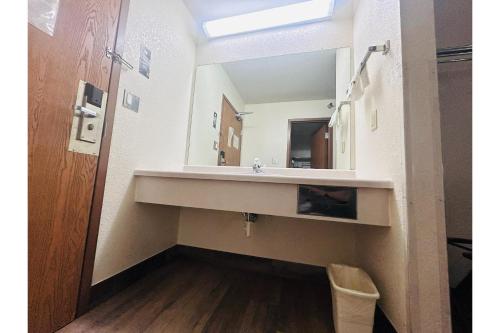 a bathroom with a sink and a mirror at Rockwood Inn Kennett I 55 Near Blytheville in Kennett