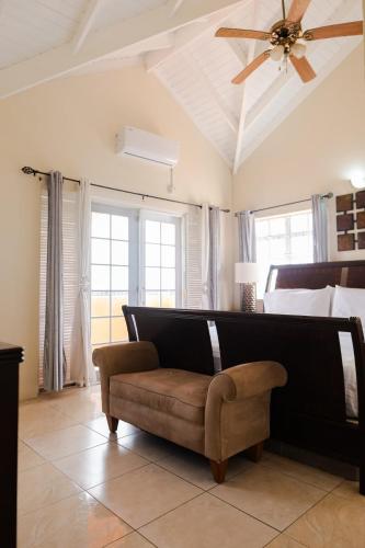 a living room with a couch and a ceiling fan at Cap Estate Ocean View Villa, Gros Islet, St Lucia in Dame de Traversay