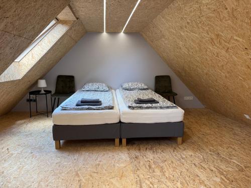 a bedroom with two beds in a attic at Apartament Zbąszynek in Zbąszynek
