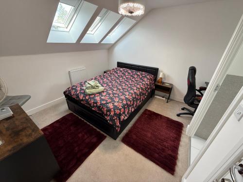 a bedroom with a bed in a room with rugs at The Trinity - Double Room Suite 1 with Study and En-suite in High Wycombe