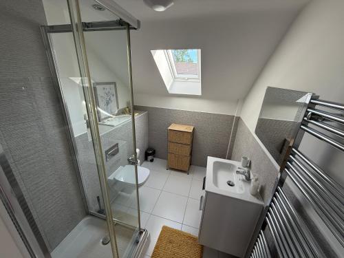 a small bathroom with a shower and a sink at The Trinity - Double Room Suite 1 with Study and En-suite in High Wycombe