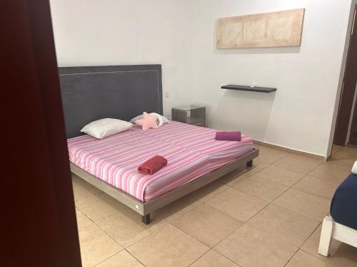 a bedroom with a large bed with purple sheets at Paraíso maya apartaments in Playa del Carmen