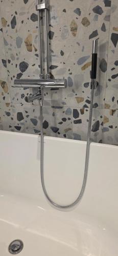 a shower hose hooked up to a sink in a bathroom at Lösen Retreat in Lyckeby