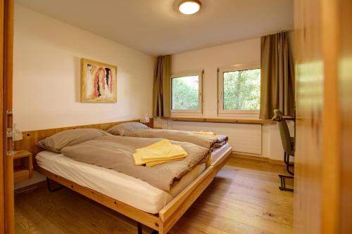a bedroom with a large bed in a room at Chesa Munteratsch 2-Zimmerwohnung 101 Typ E in Silvaplana