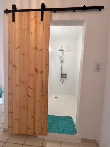 a wooden door with a green mat in a room at 7Olives Azure Boutique Apartment in Kastraki