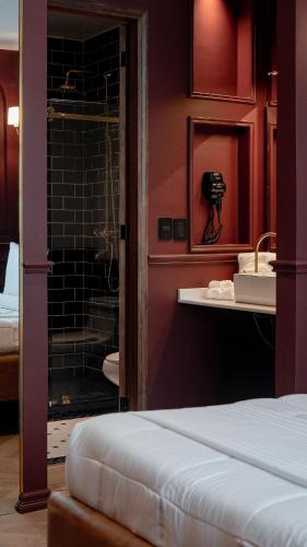 a bedroom with a bathroom with a shower at The Ruby Suite luxury room in Mexico City