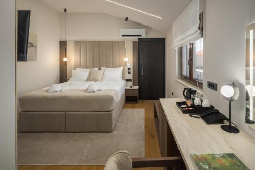 a bedroom with a bed and a desk in a room at Heritage Hotel Ames in Poreč