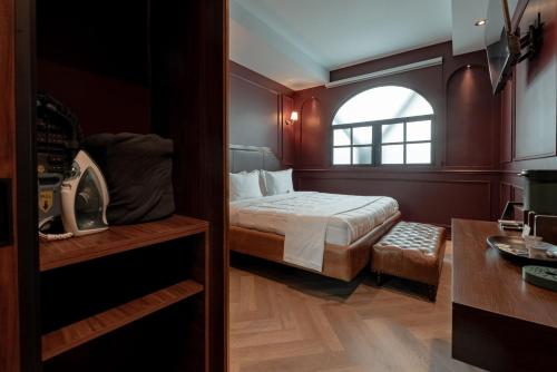 a small bedroom with a bed and a window at The Ruby Suite luxury room in Mexico City