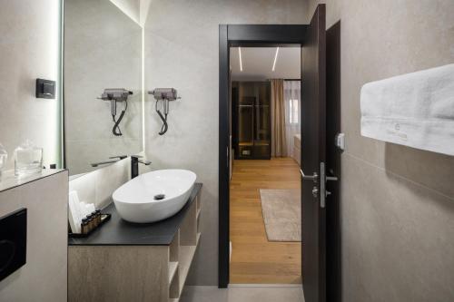 a bathroom with a sink and a mirror at Heritage Hotel Ames in Poreč