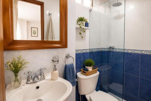 a bathroom with a sink and a toilet and a mirror at Estudio inteligente en el Corazón del Norte de Tunja Tecnología, Confort y Ubicación Top in Tunja