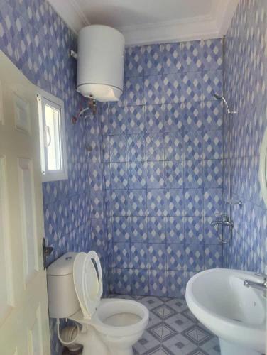 a bathroom with a toilet and a sink at The Senegambia Hideaway in Amdalai