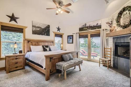 a bedroom with a bed and a fireplace at Mountain Retreat - Deck Views - Sleeps 10 in Black Hawk