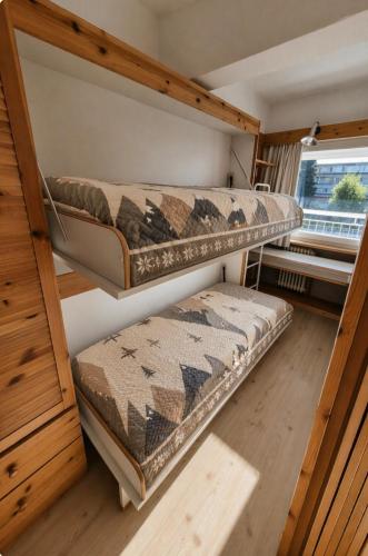 two bunk beds in a room with a window at ''BalconyView'' by Staymarilleva1400 in Marilleva