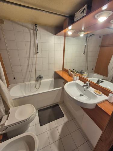 a bathroom with a sink and a toilet and a tub at ''BalconyView'' by Staymarilleva1400 in Marilleva