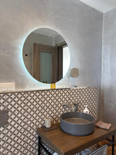 a bathroom with a sink and a mirror at Cute little Penthouse in the Heart of Sliema in Sliema