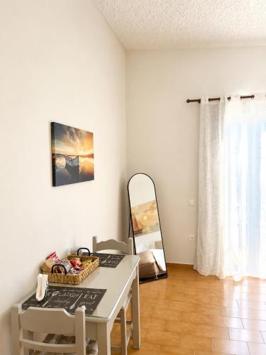 a white room with a table and a mirror at Gennadi Sun Apartments 500m from the beach in Gennadi