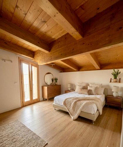 a bedroom with a large bed and wooden ceilings at Vacanze in centro a un passo dal mare in Montesilvano