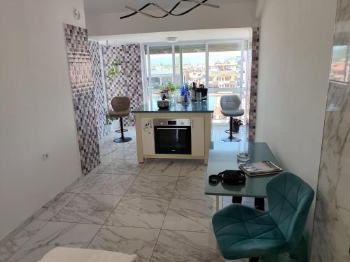 a kitchen with a table and chairs in a room at Golden Age Rooftop Apartment in Ohrid