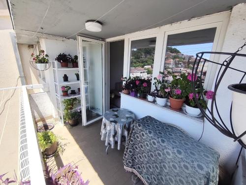 a balcony with a bench and potted plants at Golden Age Rooftop Apartment in Ohrid