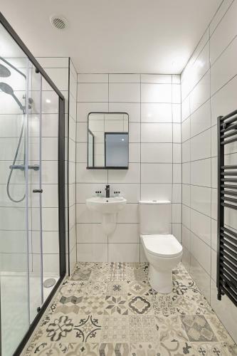 a bathroom with a toilet and a sink and a shower at The Righ in Oban