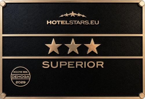 three stars on a black wall with a hilton starlezlezeu at HOTEL ATLANTA Darmstadt SUPERIOR in Darmstadt
