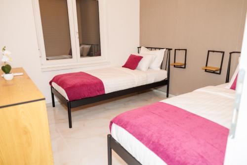 a bedroom with two beds and a mirror at Villa Merak House in Bijelo Brdo