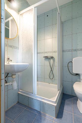 a bathroom with a shower and a sink at Home Tatra in Biały Dunajec