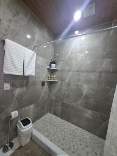 a bathroom with a shower with a tub and a toilet at Paradise 1 in Jacó